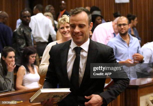 Former Paralympic champion Oscar Pistorius smiles as he leaves the North Gauteng High Court in Pretoria, South Africa, after his bail hearing, on...