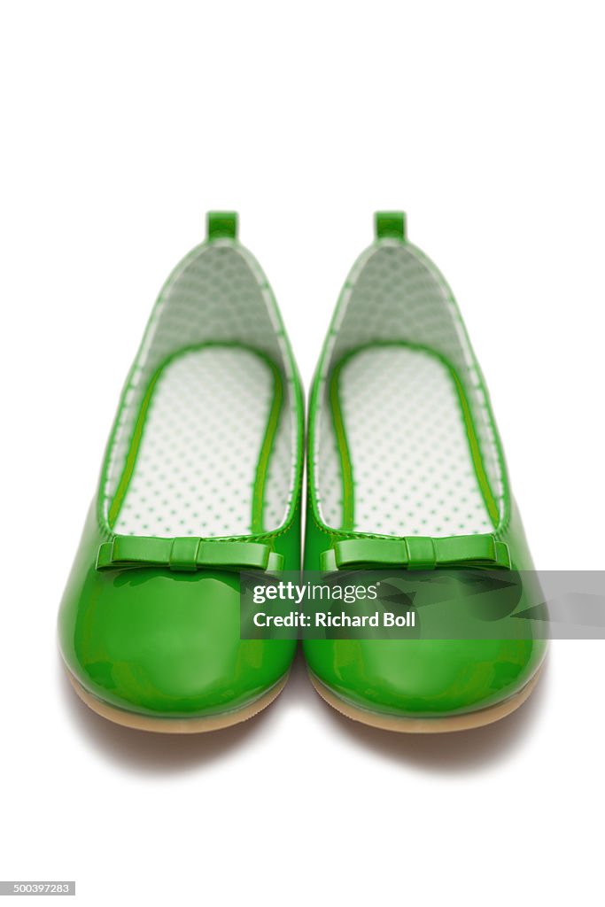 Green childrens shoes on a white background