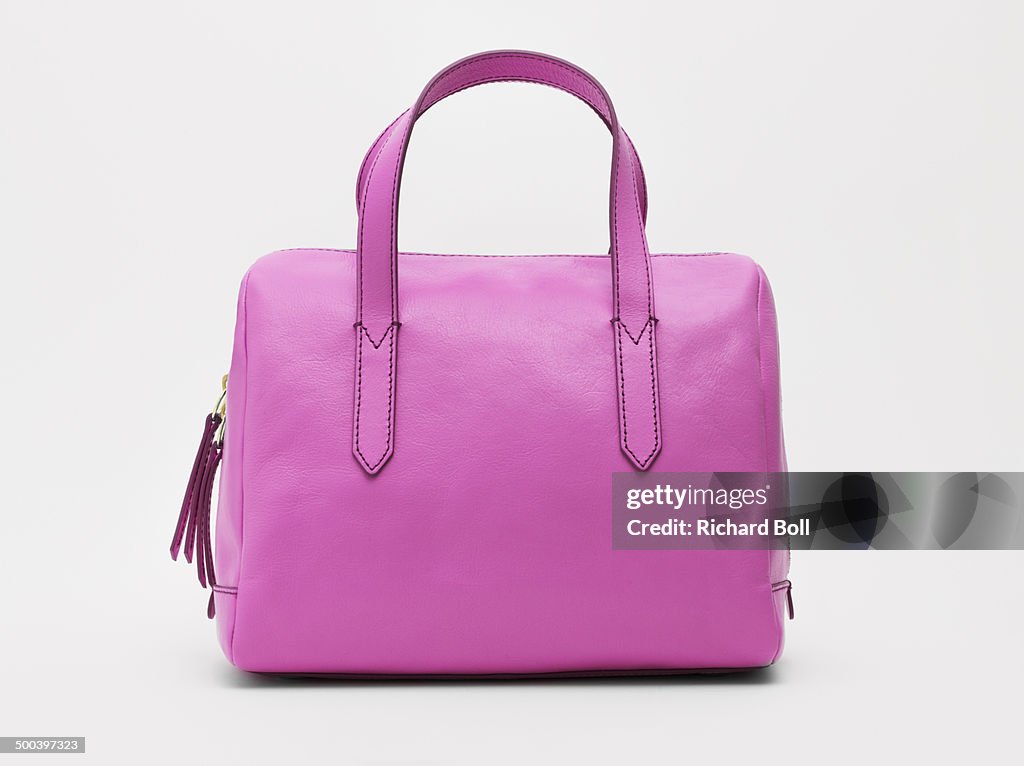 A pink handbag against a white background