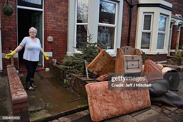 Woman satnds outside her home in Warwick road start to empty their possessions after Storm Desmond caused flooding on December 8, 2015 in Carlisle,...