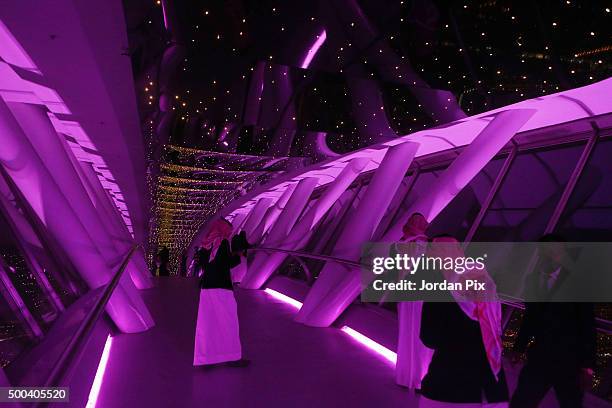 Saudis enjoy looking out over the skyline view of the city from the 99th floor - the viewing floor - at The Kingdom tower on December 7, 2015 in...