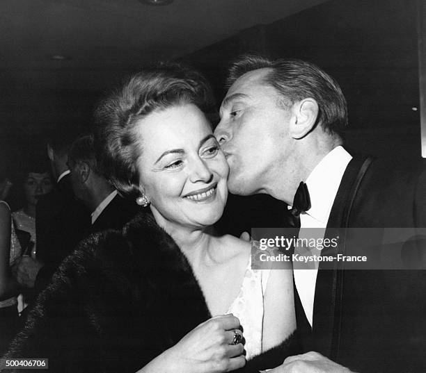 Kirk Douglas accueillant Olivia de Havilland par un enorme baiser a son arrivee a la soiree d'anniversaire du producteur Arman Deutsh a l'Hotel...