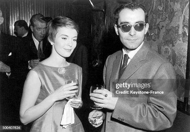 American actress Jean Seberg and French film-maker Jean-Luc Godard having drinks during the cocktail party held at the Elysee Matignon in honor of...