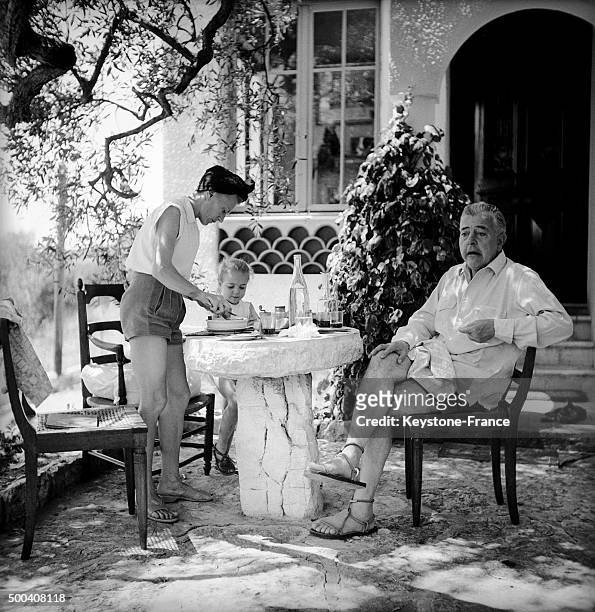 The French poet Jacques Prevert on vacation with his wife and little daughter relaxing during summer 1951 in Saint Paul de Vence, France.