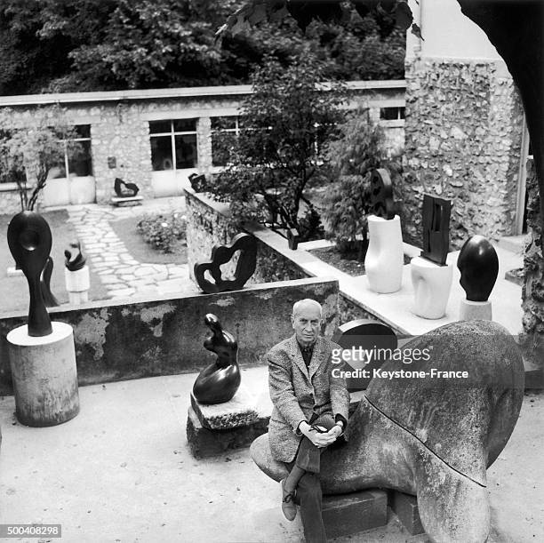 Jean Arp in the garden of his house with some of his sculptures circa 1960 in Clamart, France.