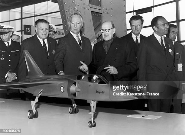 The Minister of Armies Pierre Messmer with the manufacturer Marcel Dassault in front a model of the Mirage 64 aircraft at the Paris Air Show in May,...