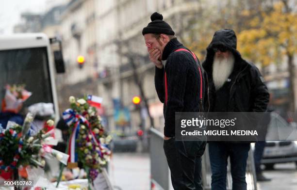 Singer of the US rock group Eagles of Death metal Jesse Hughes and guitarist Dave Catching pay tribute to the victims of the November 13 Paris...