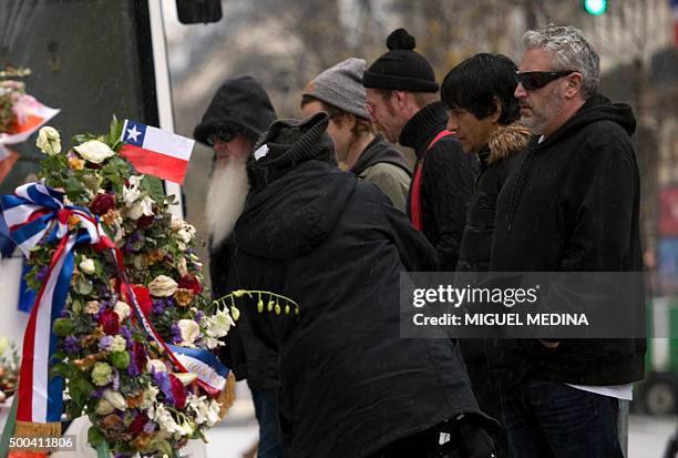 Members of US rock group Eagles of Death metal pay tribute to the victims of the November 13 Paris terrorist attacks at a makeshift memorial in front...