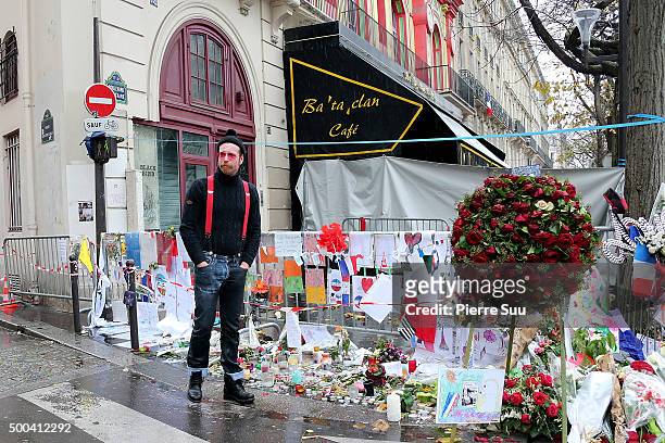 Eagles of Death Metal frontman Jesse Hughes shows his emotions as he looks at the flower memorial in front of The Bataclan concert hall on December...