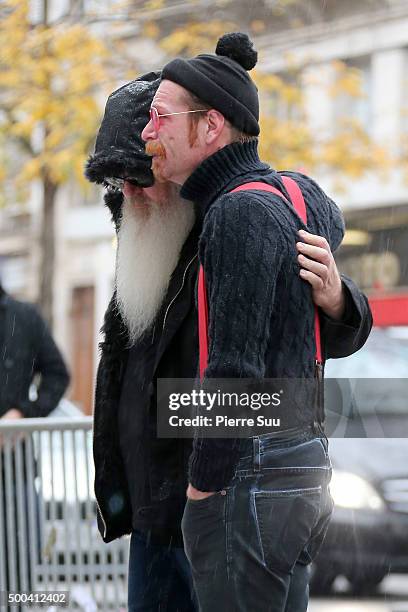 Dave Catching and Jesse Hughes of Eagles of Death Metal show their emotions as they looks at the flower memorial in front of The Bataclan concert...