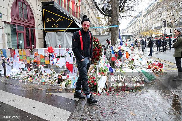 Eagles of Death Metal frontman Jesse Hughes shows his emotions as he looks at the flower memorial in front of The Bataclan concert hall on December...