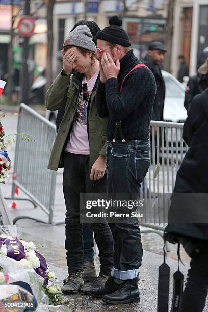 Julian Dorio and Jesse Hughes of Eagles of Death Metal show their emotions as they look at the flower memorial in front of The Bataclan concert hall...