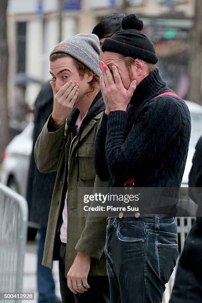 Julian Dorio and Jesse Hughes of Eagles of Death Metal show their emotions as they look at the flower memorial in front of The Bataclan concert hall...