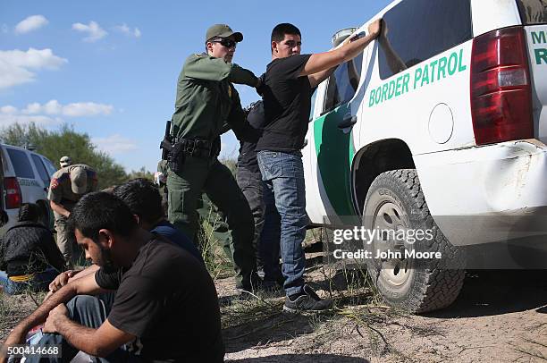 Border Patrol officer body searches an undocumented immigrant after he illegally crossed the U.S.-Mexico border and was caught on December 7, 2015...