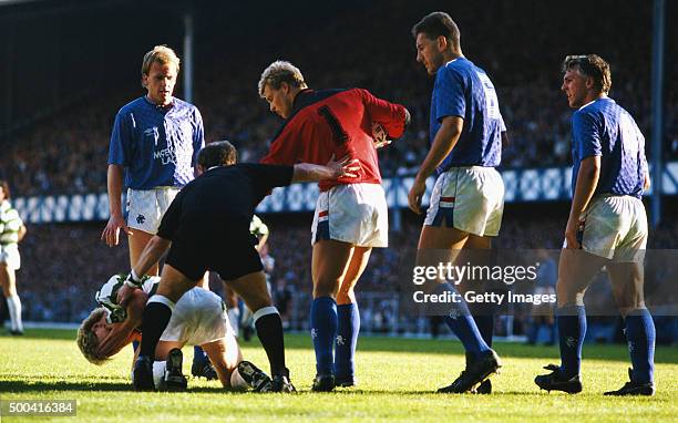 Referee Jim Duncan seperates Celtic striker Frank McAvennie from Rangers goalkeeper Chris Woods whilst John McGregor Terry Butcher and Graham Roberts...