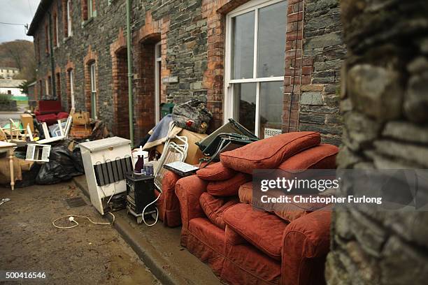 Water damaged possessions sit outside a flooded home on December 8, 2015 in Keswick, United Kingdom. Engineers are working to reconnect thousands of...