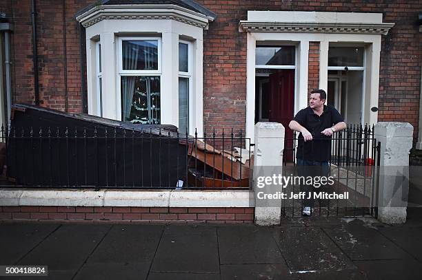 Alex Pagan stands outside his house in Broad street as people start to return to their properties after Storm Desmond caused flooding on December 8,...