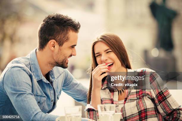happy young couple in a city cafe - coffee drink stock pictures, royalty-free photos & images