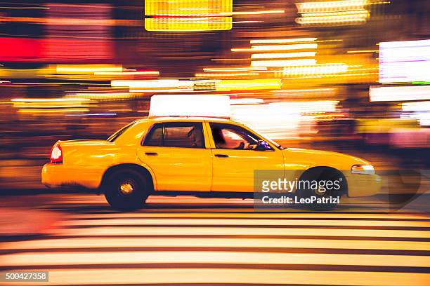 yellow cab traffic in times square - taxi stock pictures, royalty-free photos & images