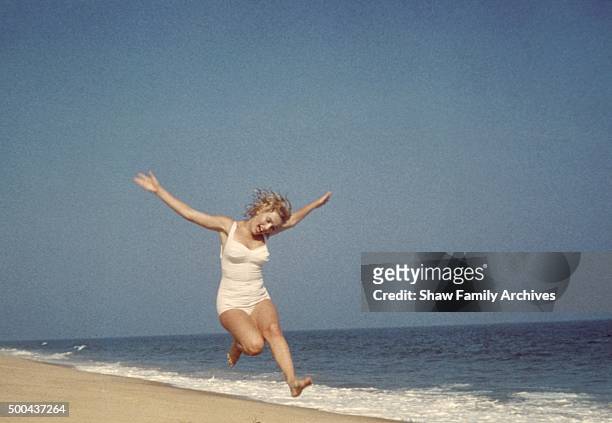Marilyn Monroe jumping on the beach in 1957 in Amagansett, New York.