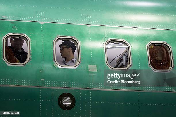 Employees work on the interior of a Boeing Co. 737 Max airplane on the production line at the company's manufacturing facility in Renton, Washington,...