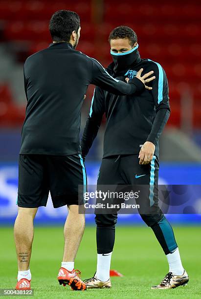 Neymar jokes with Luis Suarez during a FC Barcelona training session on the eve of the UEFA Champions League groupe E match against Bayer Leverkusen...