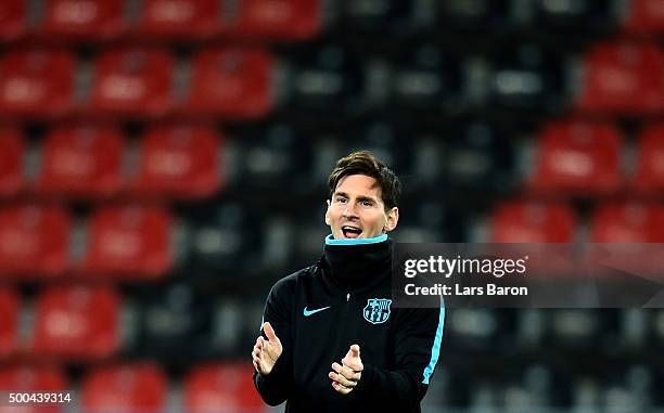 Lionel Messi smiles during a FC Barcelona training session on the eve of the UEFA Champions League groupe E match against Bayer Leverkusen at...