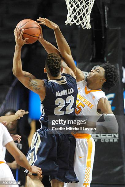 Joe McDonald of the George Washington Colonials takes a shot over Shembari Phillips of the Tennessee Volunteers during game two of the Barleys...