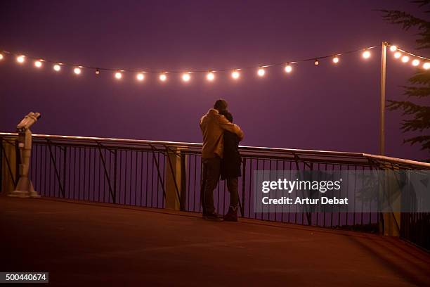 romantic view of a couple in the tibidabo viewpoint in a winter foggy night. - love at first sight stock pictures, royalty-free photos & images