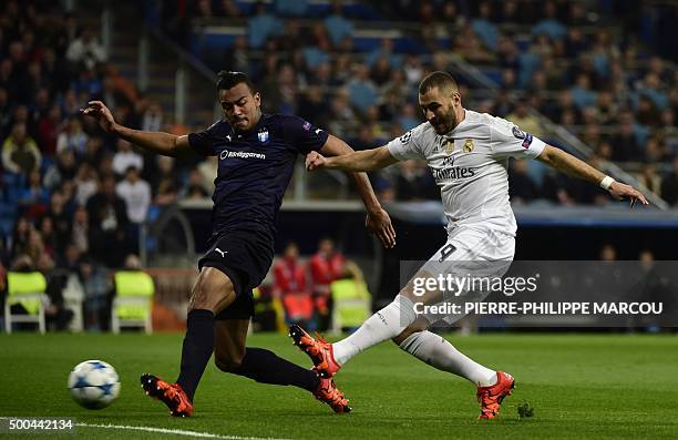 Real Madrid's French forward Karim Benzema kicks the ball past Malmo's Uruguayan defender Felipe Carvalho during the UEFA Champions League Group A...
