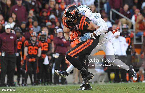 Tight end Bucky Hodges of the Virginia Tech Hokies is hit following his reception by cornerback M.J. Stewart of the North Carolina Tar Heels in the...