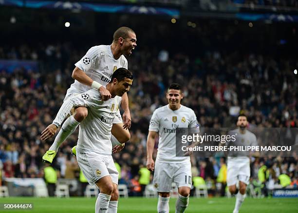 Real Madrid's Portuguese forward Cristiano Ronaldo celebrates with Real Madrid's Portuguese defender Pepe after scoring during the UEFA Champions...