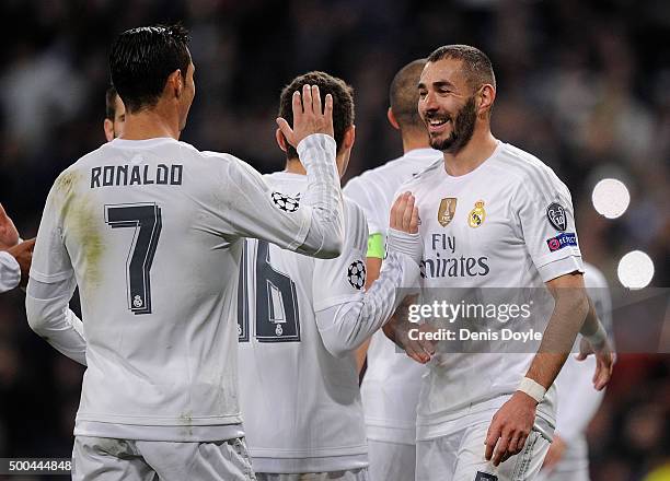 Karim Benzema of Real Madrid celebrates with Cristiano Ronaldo after scoring Real's 2nd goal during the UEFA Champions League Group A match between...