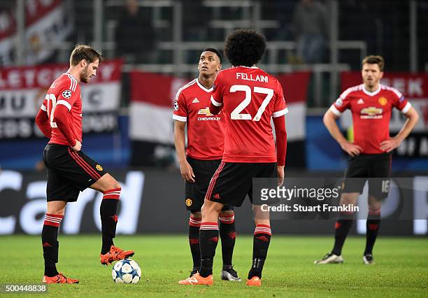 Dejected Manchester United players look on after conceding a third goal during the UEFA Champions League group B match between VfL Wolfsburg and...