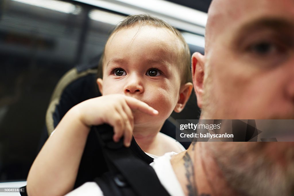 Father with son on back on train