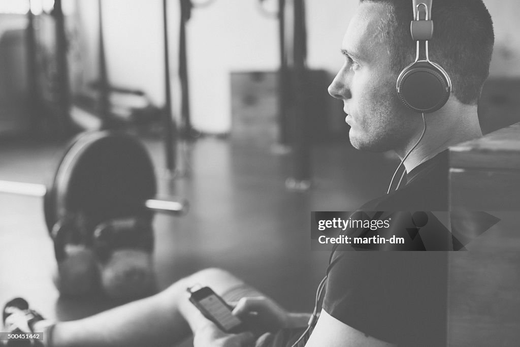 Sportsman in the gym with headphones