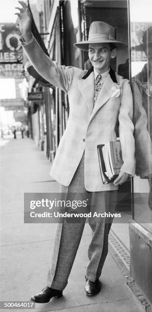 Man wearing the very latest in zoot-suit styles and a hat to match, Chicago, Illinois, September 24, 1943. The new style reflects War Production...