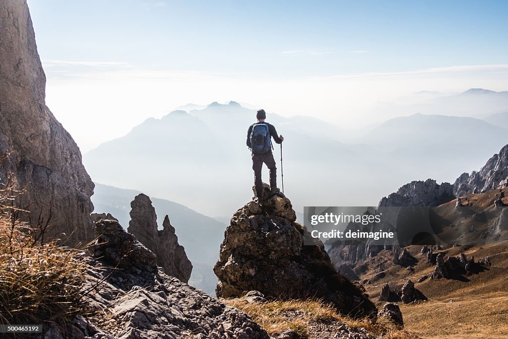 Climber enjoys the view from the top of the mountain