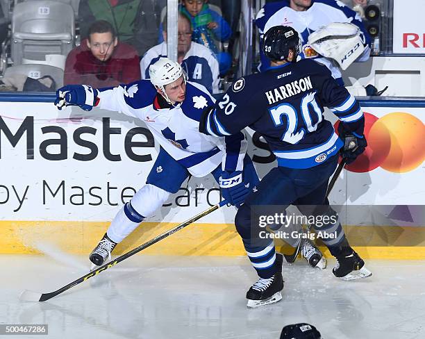 Jay Harrison of the Manitoba Moose ties up Casey Bailey of the Toronto Marlies during AHL game action on December 5, 2015 at the Ricoh Coliseum in...