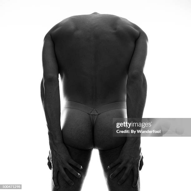 male ballet dancer poses dance moves in a studio against a white background - male bum fotografías e imágenes de stock