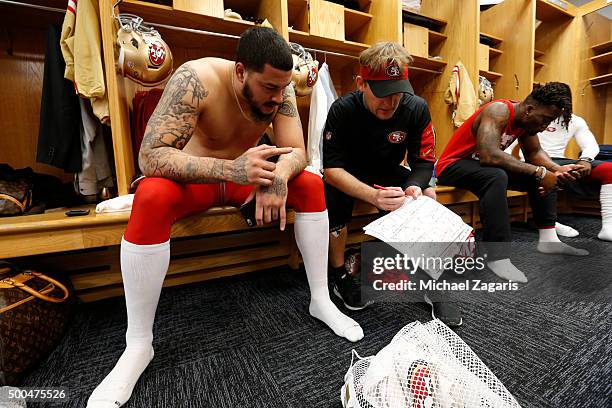 Aaron Lynch of the San Francisco 49ers talks with Linebackers Coach Jason Tarver in the locker room prior to the game against the Chicago Bears at...