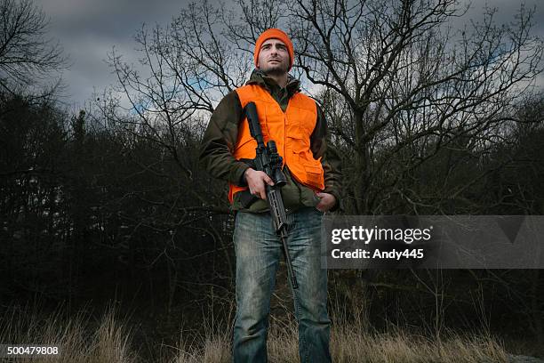 hunter with a rifle - orange camouflage stock pictures, royalty-free photos & images