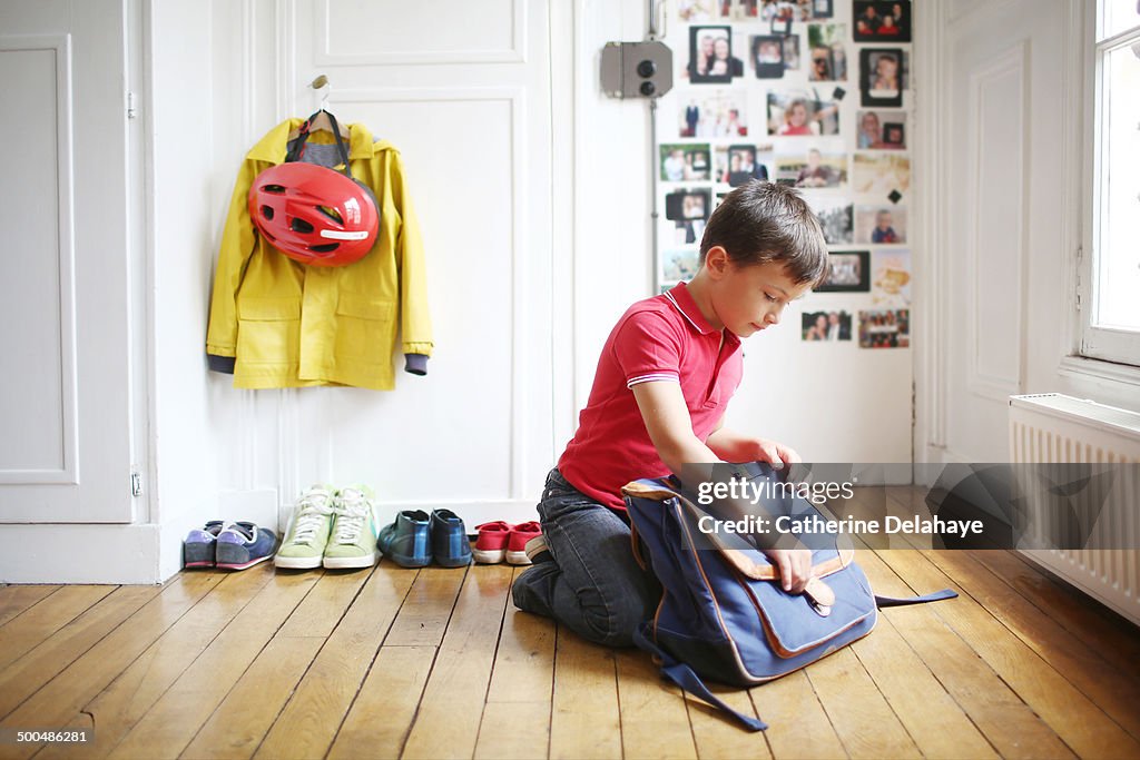 A 7 years old boy is ready to go to school