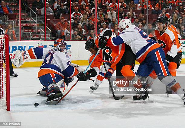 Wayne Simmonds of the Philadelphia Flyers sends the puck past goaltender Jaroslav Halak of the New York Islanders during a power play in the second...