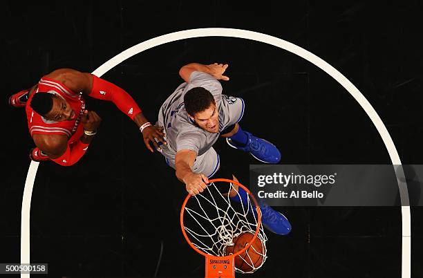 Brook Lopez of the Brooklyn Nets dunks against Dwight Howard of the Houston Rockets during their game at the Barclays Center on December 8, 2015 in...