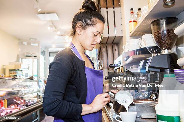 female waitress making coffee in delicatessen shop - ober stockfoto's en -beelden