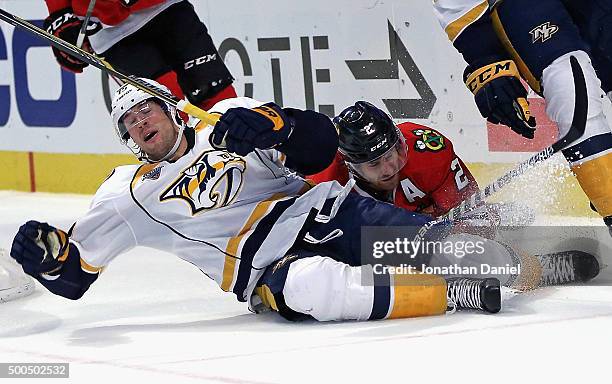 Craig Smith of the Nashville Predators hits the ice after colliding with Duncan Keith of the Chicago Blackhawks at United Center on December 8, 2015...