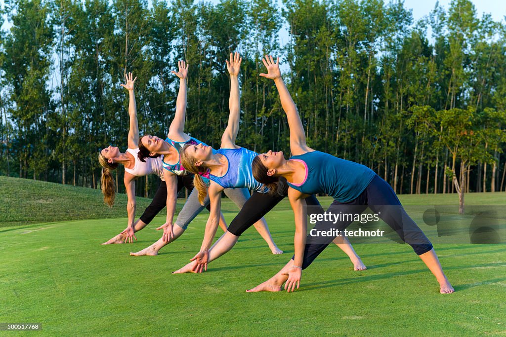 Women Doing Yoga in the Park