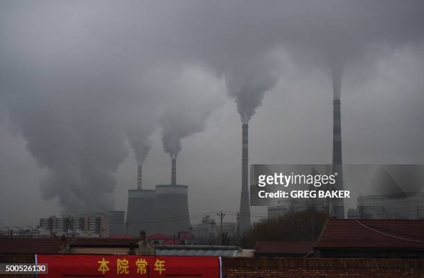 In this photo taken on November 19 smoke belches from a coal-fueled power station near Datong, in China's northern Shanxi province. For decades coal...
