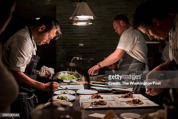 Chef Nick Stefanelli, left, works the line creating dishes at Masseria in Washington DC on Wednesday December 2, 2015. Sous Chefs Sean Tener and...